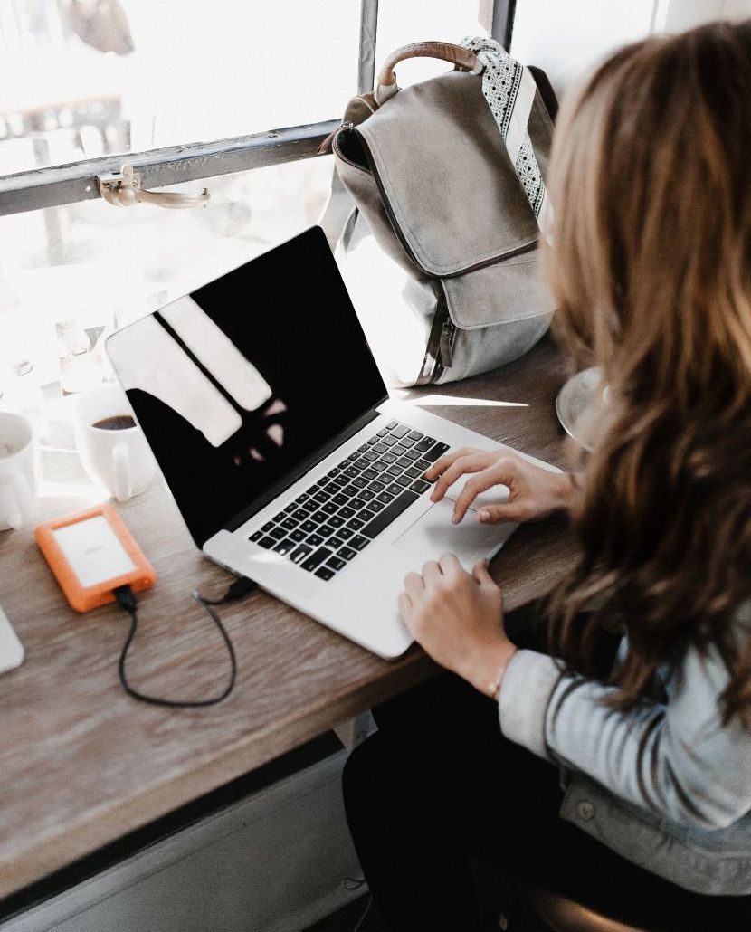 A woman typing on her laptop
