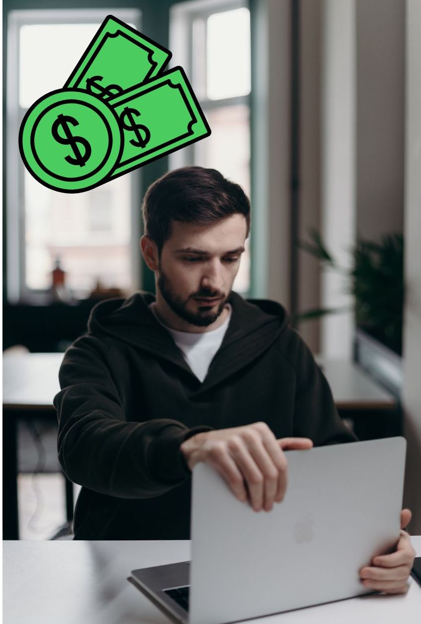 A man with laptop and money symbols