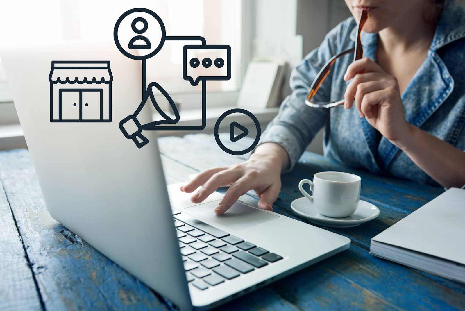 Marketing icons and a person typing on laptop