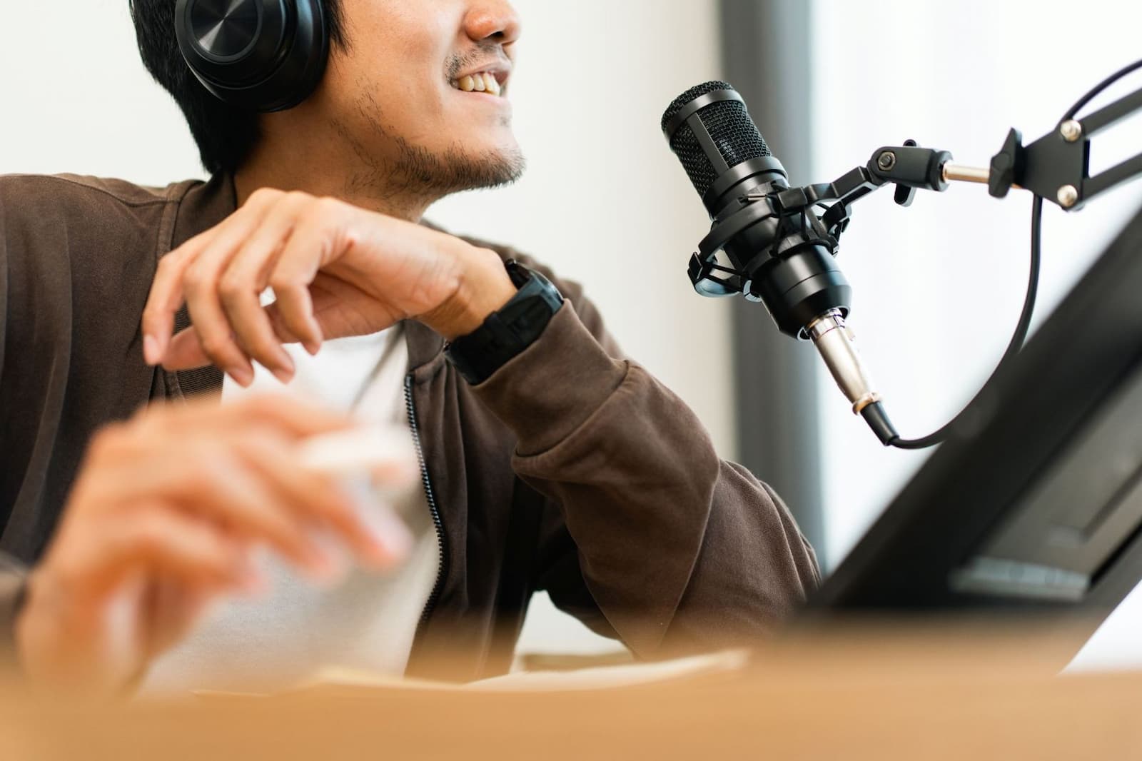 A person with headphones in front of the microphone